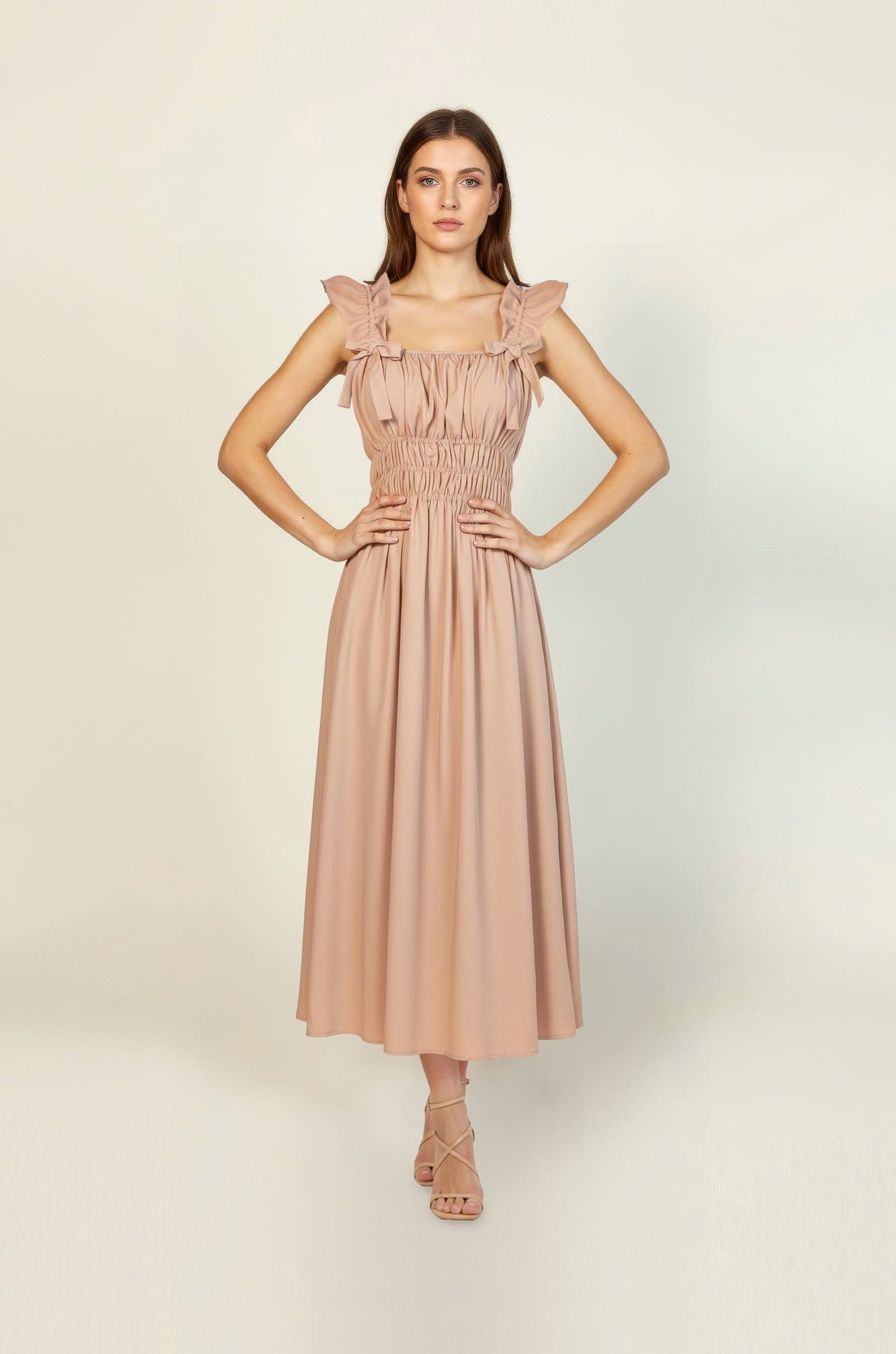 Woman wearing a pink dress against a white background