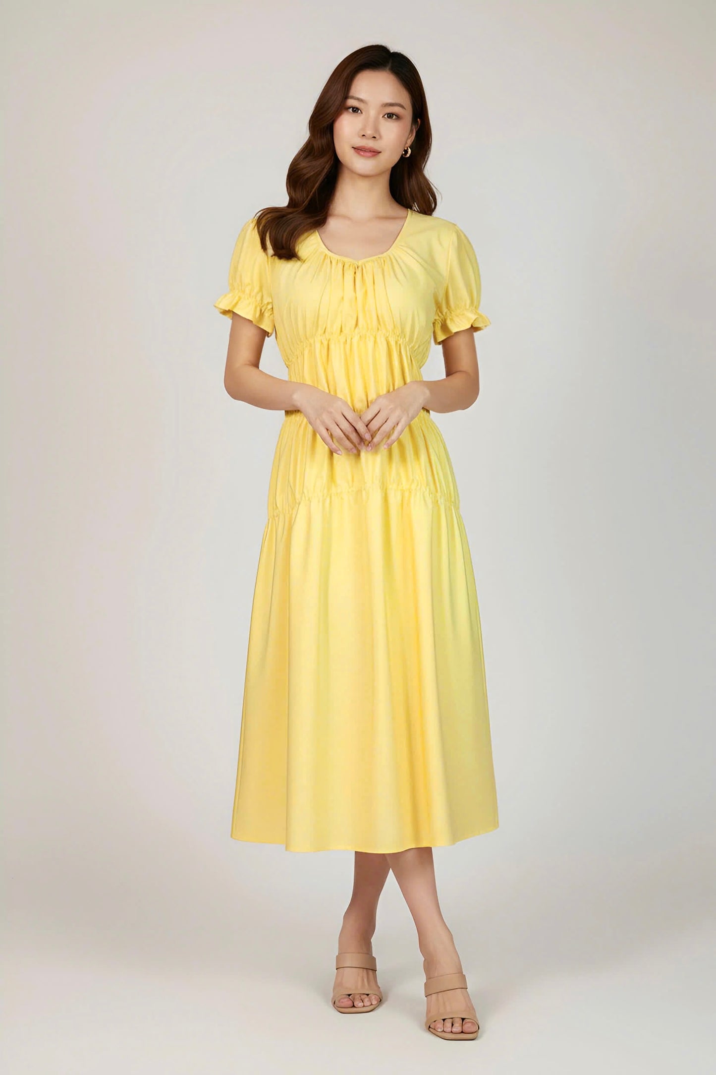 Woman wearing a yellow dress on a white background
